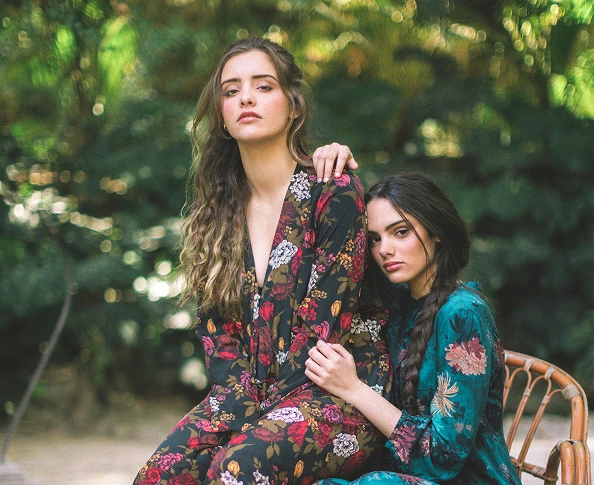 Women wearing custom floral dresses showcasing garment tailoring in Dubai